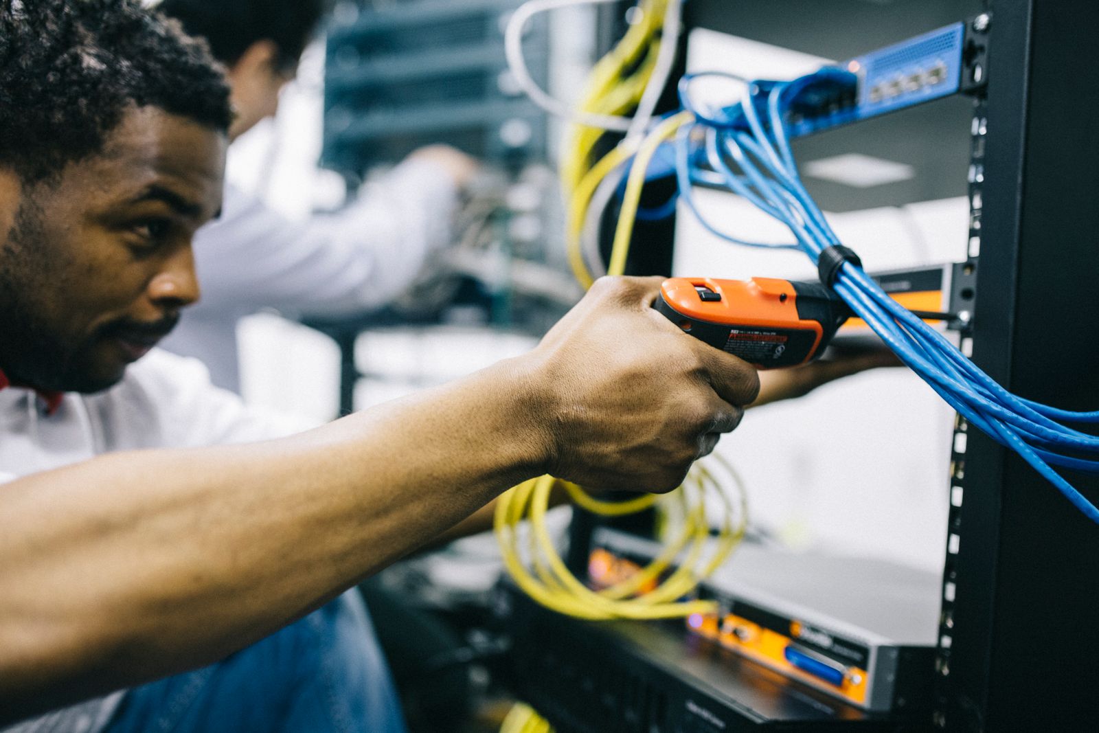 MTS network engineer configuring a server cabinet in a data center